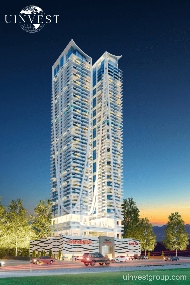 Elitz 2 twin glass towers with landscaped forecourt under a clear blue sky in Jumeirah Village Circle, Dubai.