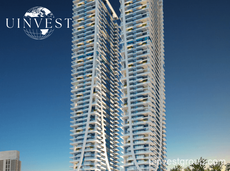 Elitz 2 twin glass towers with landscaped forecourt under a clear blue sky in Jumeirah Village Circle, Dubai.