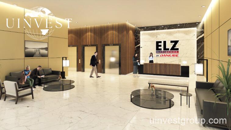 Two 20-storey ELZ towers linked by a skybridge, framed by landscaped gardens under a clear blue sky.