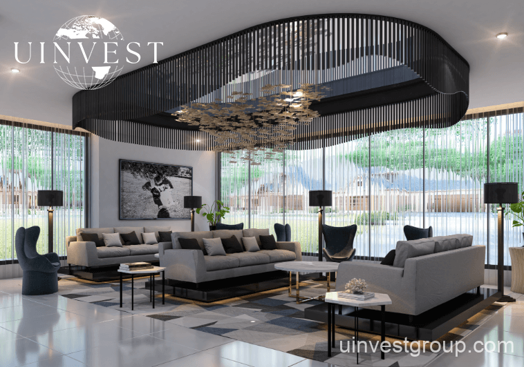 Spacious double-height lobby at Elitz 3 featuring modern seating, marble floors, and a concierge desk.