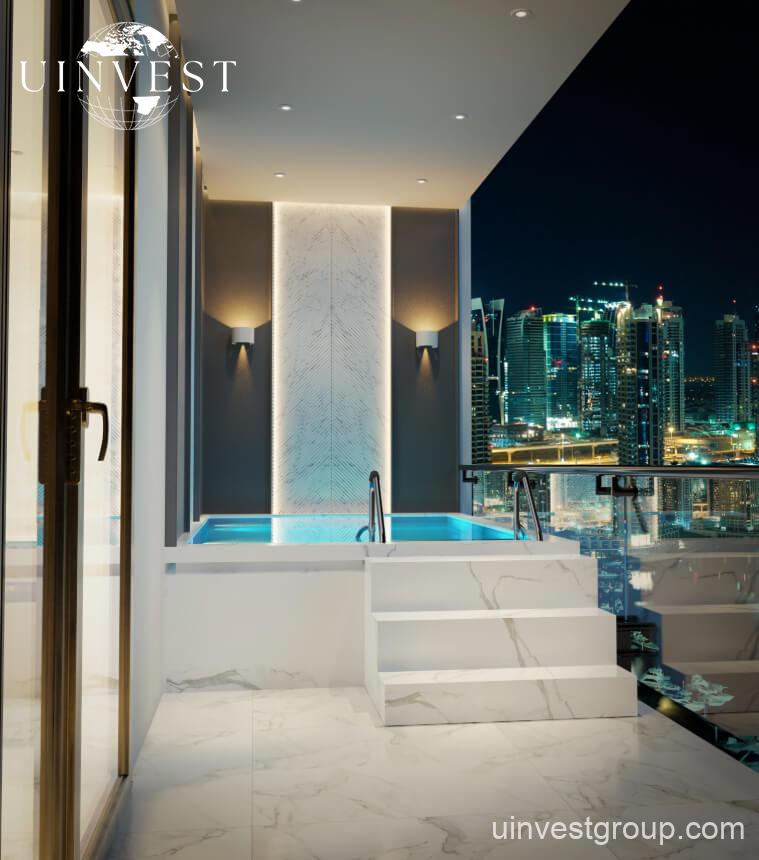 Elitz 3 twin glass towers with landscaped forecourt under a clear blue sky in Jumeirah Village Circle, Dubai.