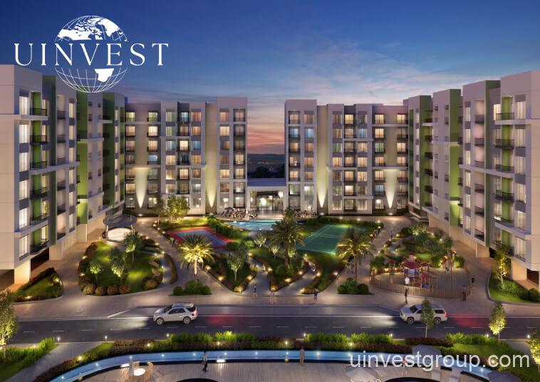 Rendering of Olivz by Danube’s modern residential towers in Al Warsan First, Dubai, featuring neutral-toned façades, landscaped gardens, water features, and swimming pools.