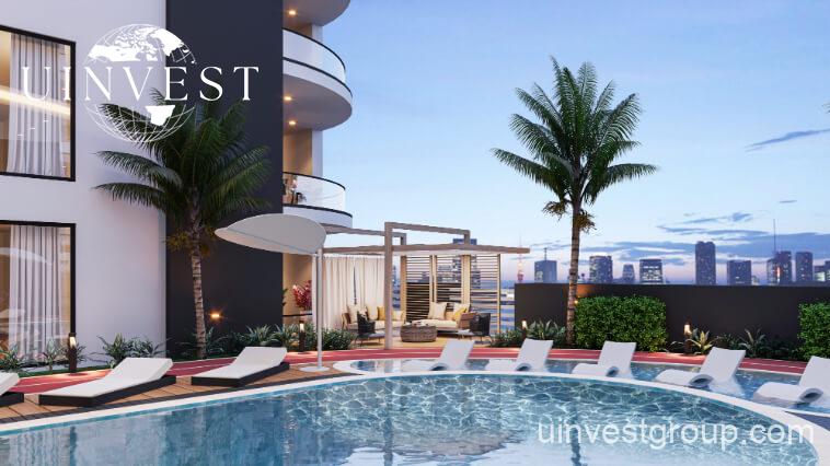 Architectural rendering of Opalz by Danube’s twin 19-storey residential towers in Arjan, Dubai, showcasing neutral-toned façades, private balconies overlooking landscaped water bodies, and integrated leisure facilities.