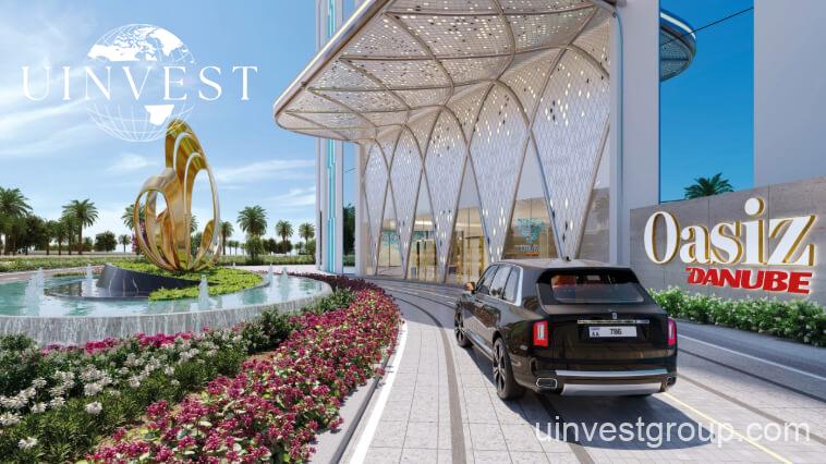 Exterior view of Oasiz by Danube in Dubai Silicon Oasis, a 38-storey glass-clad tower with landscaped podium and central pool.