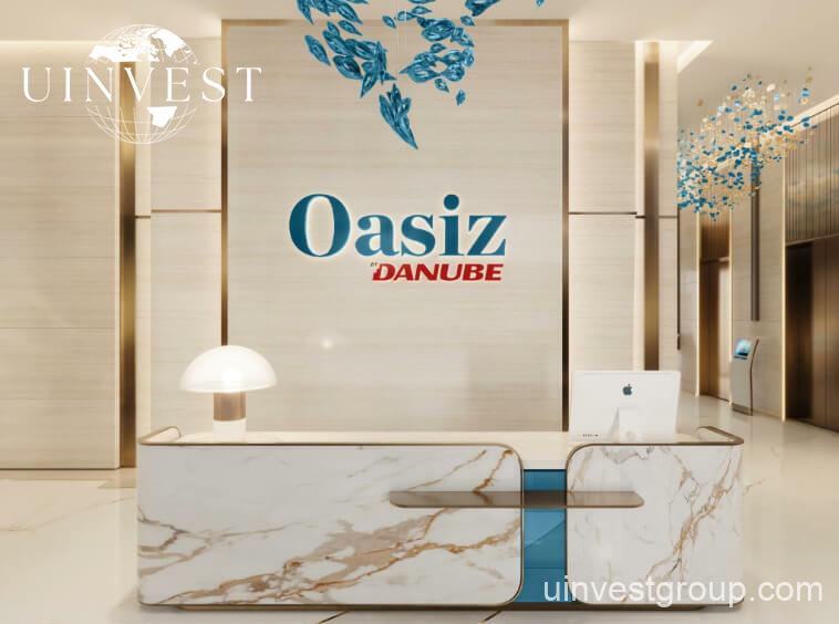 Exterior view of Oasiz by Danube in Dubai Silicon Oasis, a 38-storey glass-clad tower with landscaped podium and central pool.