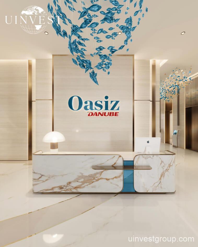 Exterior view of Oasiz by Danube in Dubai Silicon Oasis, a 38-storey glass-clad tower with landscaped podium and central pool.