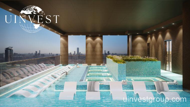 Exterior view of Skyz by Danube tower in Arjan, Dubailand, featuring terraced green sky gardens, open-air plazas, and Mediterranean-themed architecture.