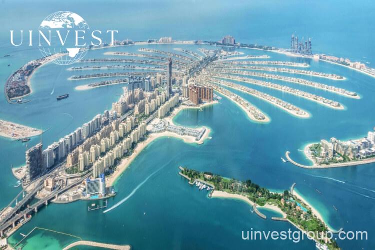Aerial shot of Palm Jumeirah, highlighting its iconic palm-shaped layout and luxurious beachfront properties.