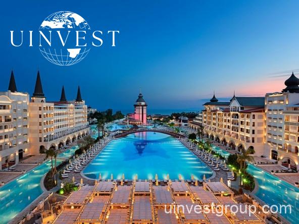 Luxury Turkish hotel exterior with lush gardens, perfect getaway for male travelers seeking comfort and nature.