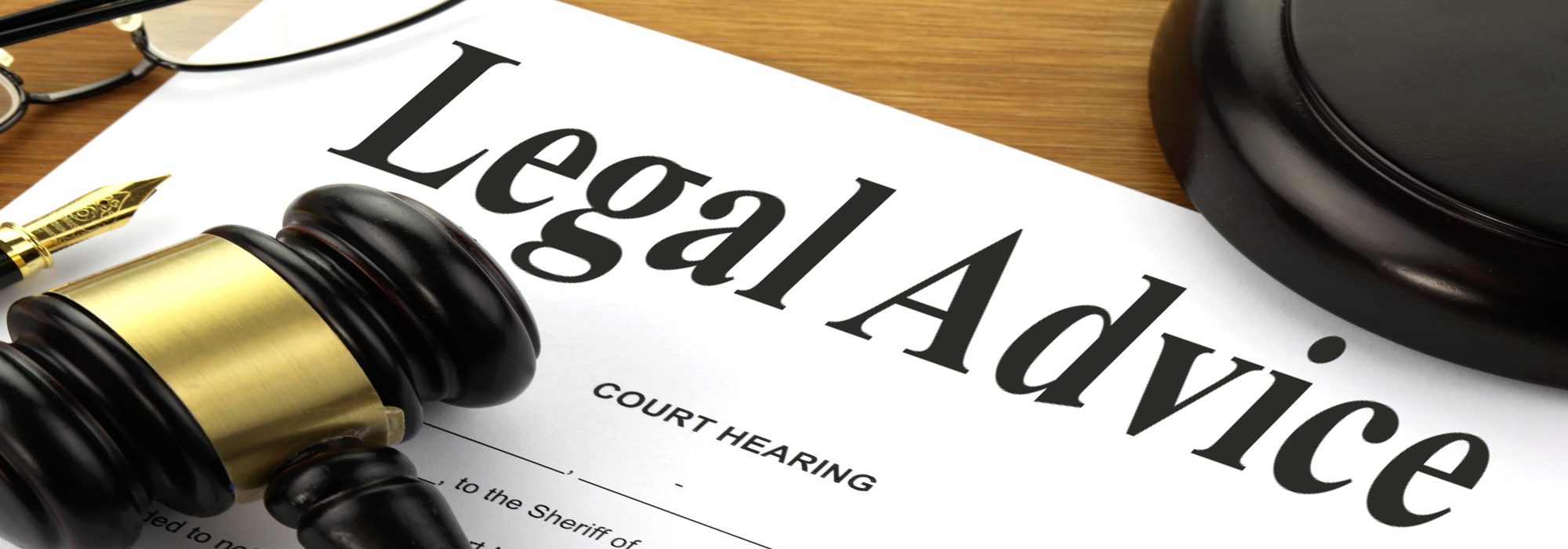 Legal advice document with gavel and glasses on a desk, representing 24/7 legal support for international property buyers