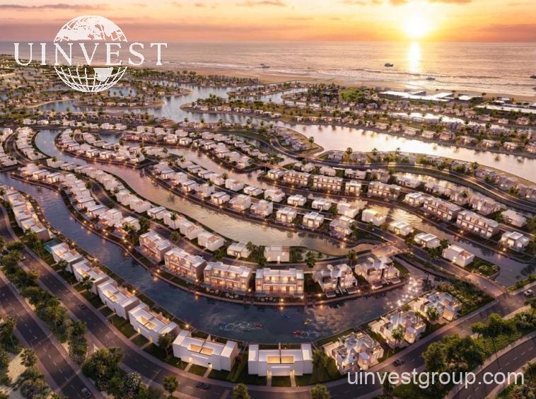 Aerial rendering of Lubana Island at Amazi, Hawana Salalah, showing waterfront villas and chalets around landscaped lagoons at sunset
