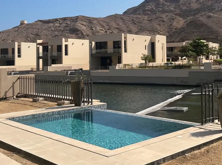 Villa pool overlooking the marina channel at Muscat Bay