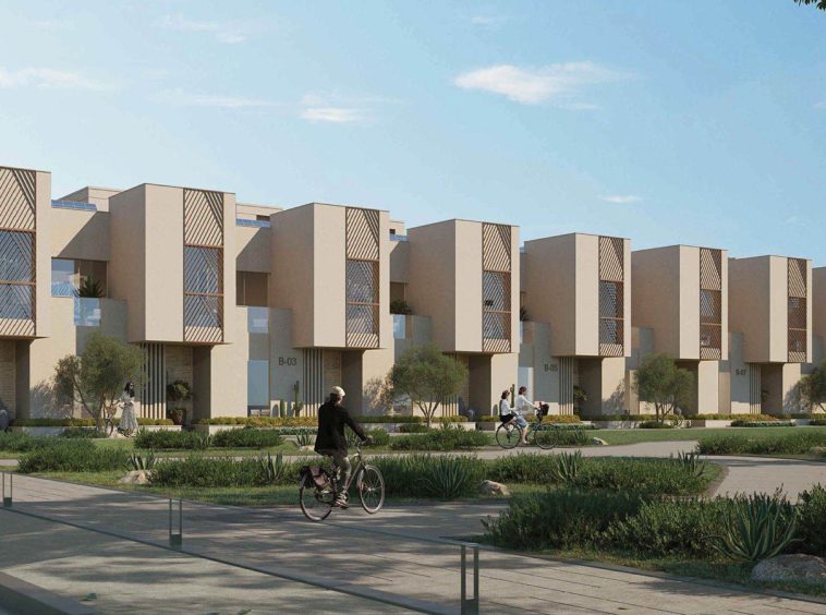 Hay Al Wafa homes fronting landscaped grounds and cycling paths in Sultan Haitham City, Oman.