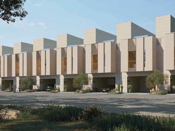 Three-storey townhouses at Hay Al Wafa in Sultan Haitham City, Muscat, with light beige stone facades and decorative metal grilles.