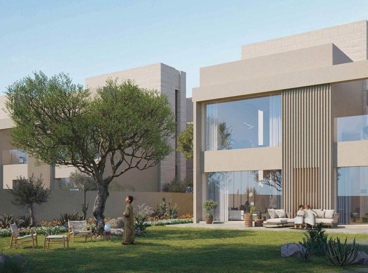 A five-bedroom villa at Hay Al Wafa with private garden and full-height glazing opening onto the lawn.