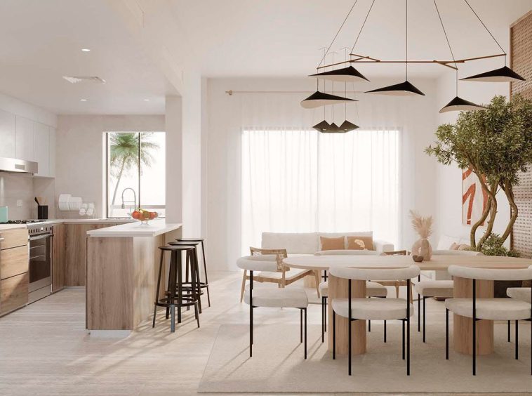 Fitted kitchen with installed appliances and open dining area in an apartment at The Sustainable City Yiti.