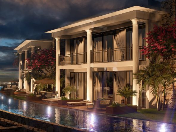 Night view of Aloha Beach Resort two-storey homes beside a lit pool