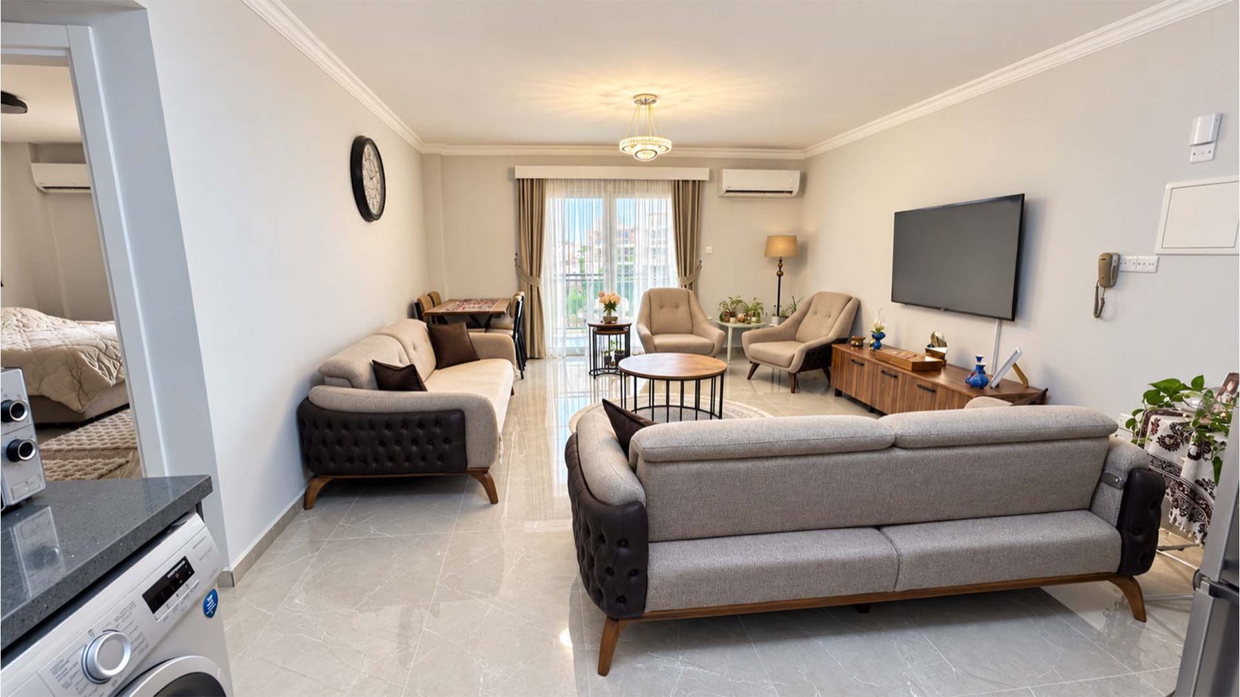 Angel Towers apartment living room with sofas and wall-mounted television
