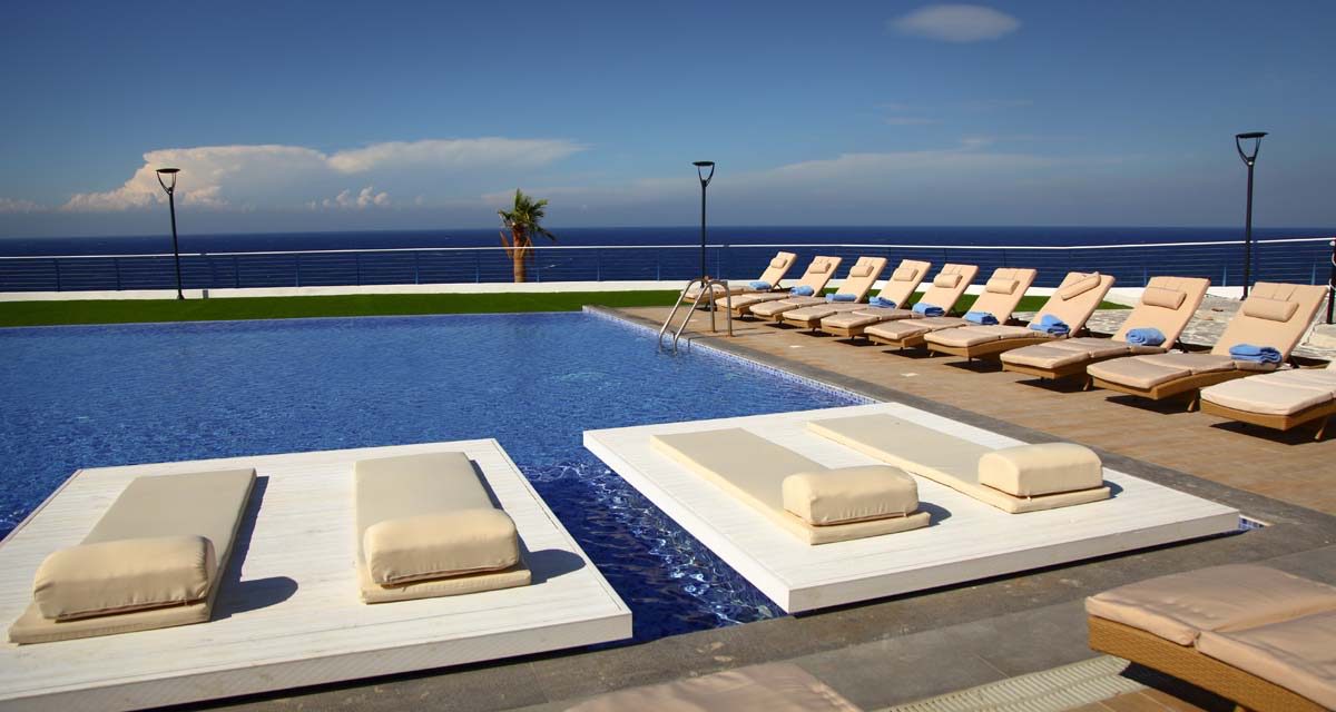 Caesar Cliff pool with loungers facing the sea