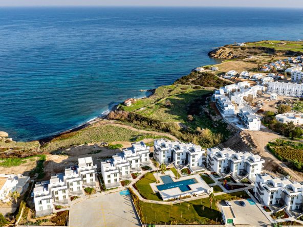 Aerial view of white apartment blocks on the coast above the sea
