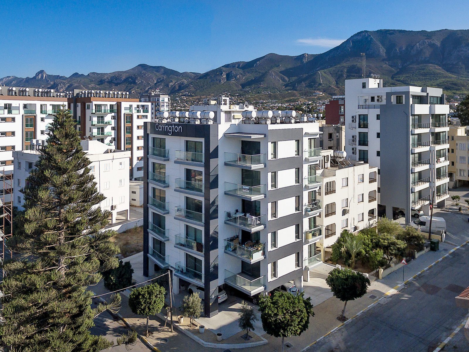 Elevated view of the Carrington 11 building with the Kyrenia mountain range behind