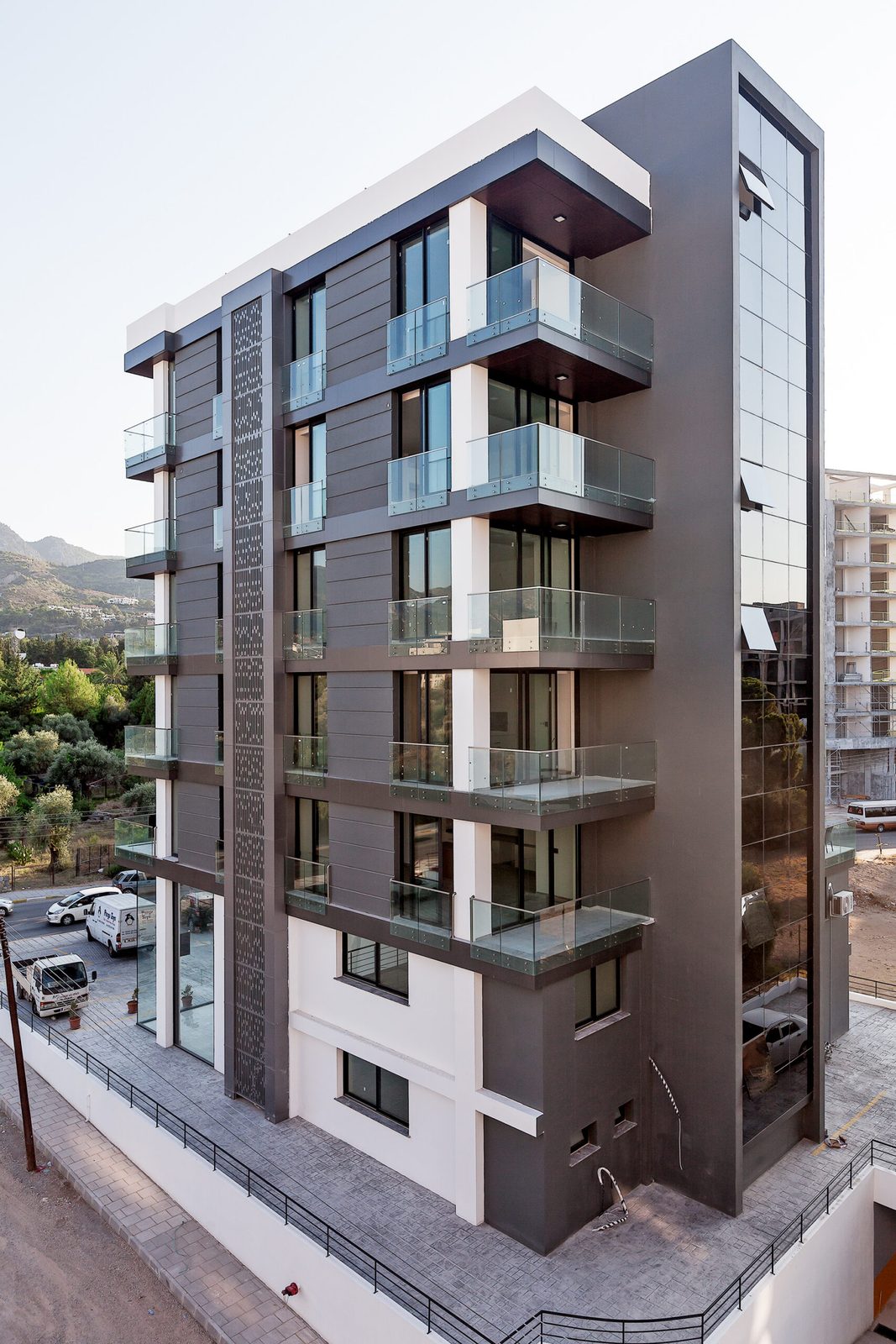 Photo of the building side elevation in evening light from an elevated viewpoint
