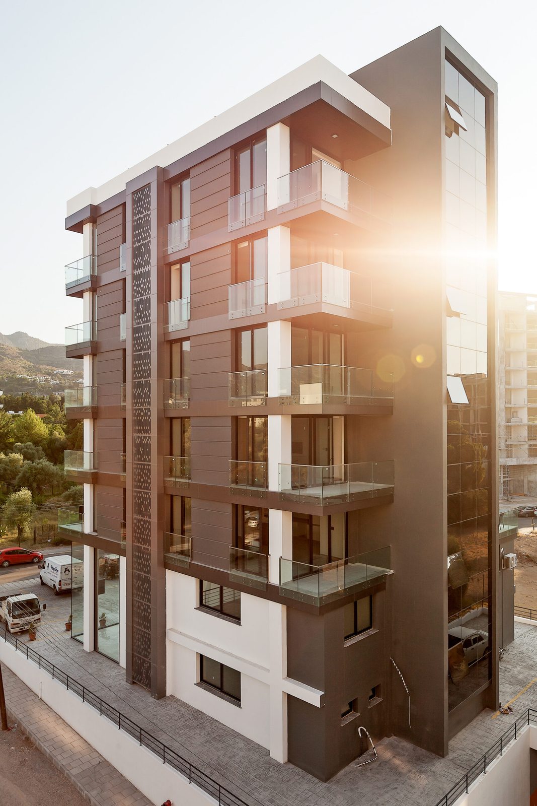 Photo of the same side elevation with sun flare (near-duplicate of previous view)