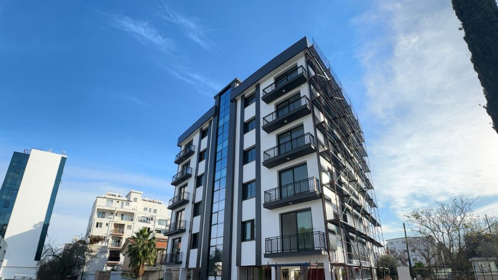 Carrington 55 Kyrenia apartment block facade with balconies and glazed stair column