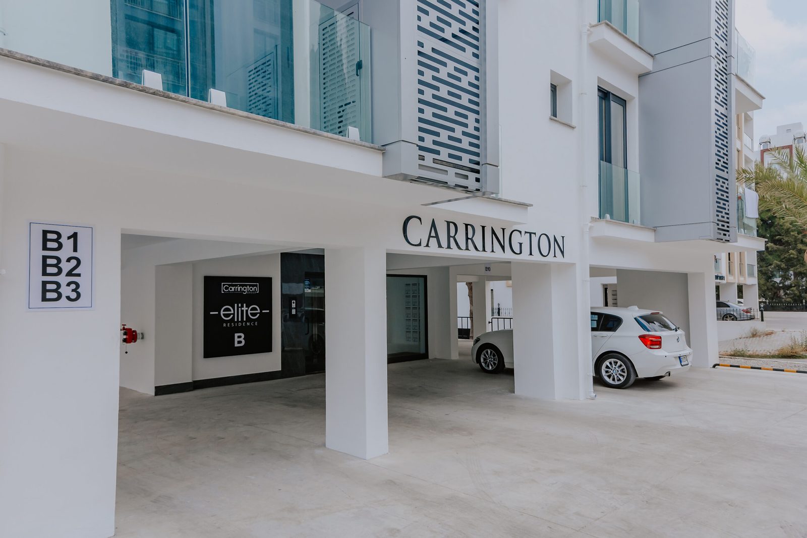 Photo of the ground-floor entrance canopy with block numbers and the Carrington sign