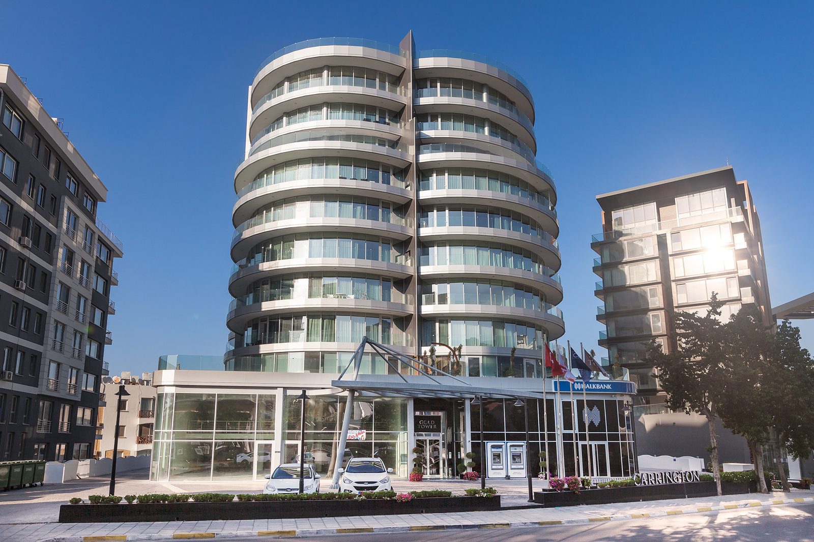 Photo of the curved balcony tower with a glazed ground-floor entrance pavilion