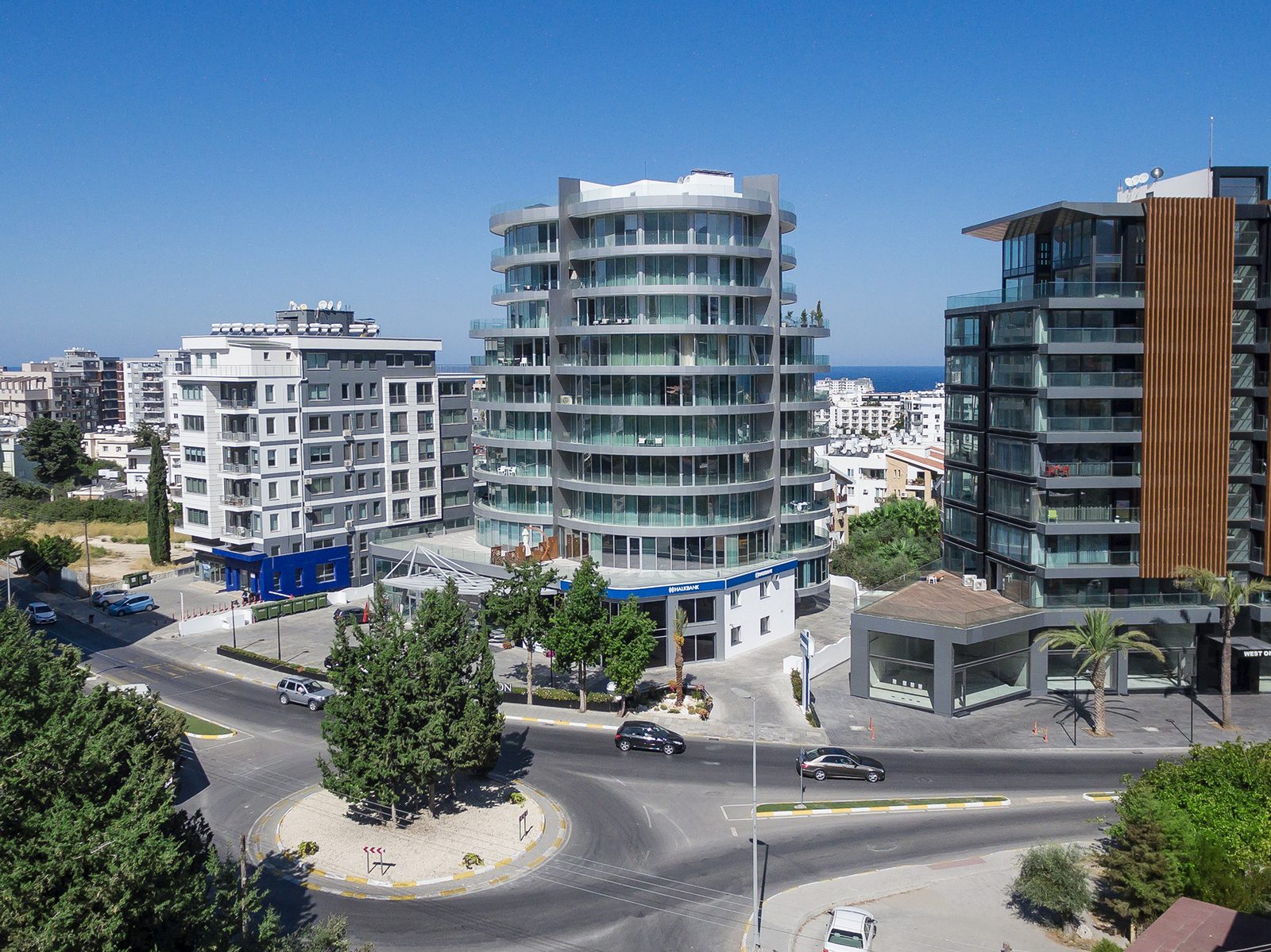 Elevated photo of the tower and a neighbouring building beside a roundabout