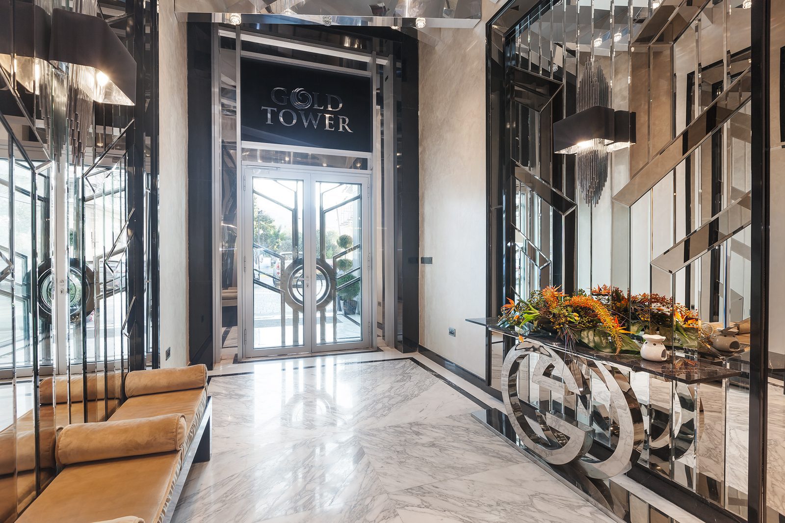 Photo of the marble entrance lobby with the Gold Tower sign above glass doors