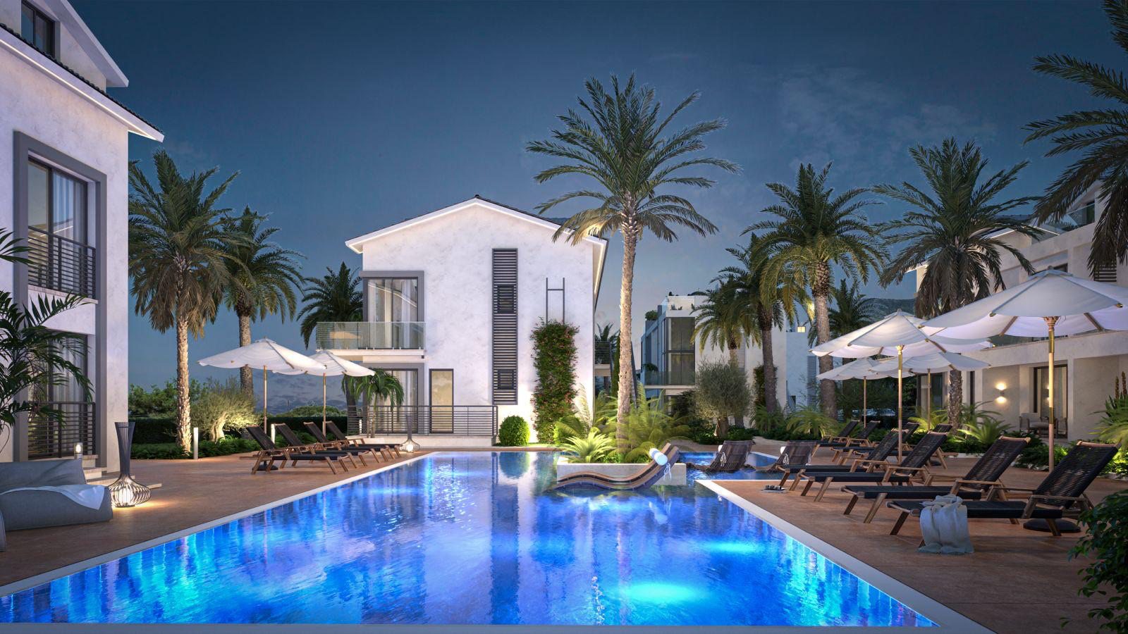 Render: evening view of the pool lit up beside the apartment blocks