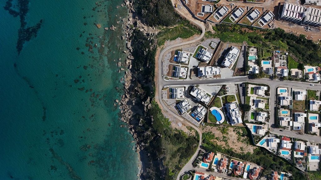 Poseidon Girne Bahceli: aerial photo of white buildings with pools beside the sea