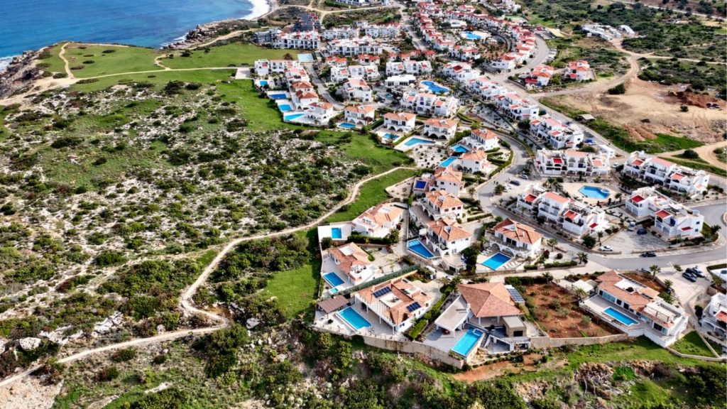 Sea Magic Esentepe community: aerial view of white villas and apartments on the coast
