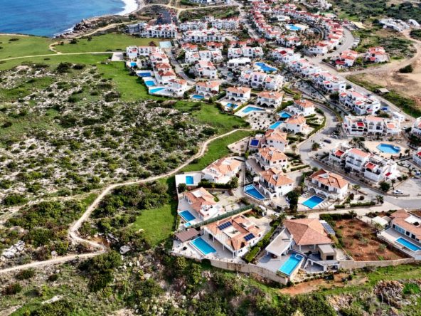 Aerial view of the Sea Magic community of white villas and apartments on the coast