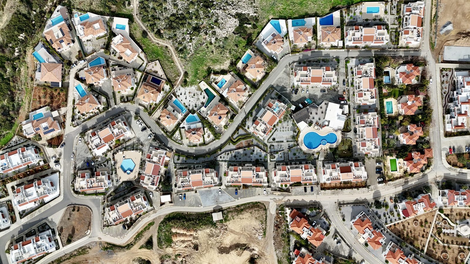 Top-down aerial view of Sea Magic roads, villas and a communal pool