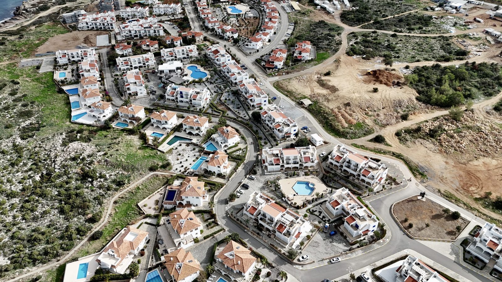 Aerial view of Sea Magic buildings and private pools on the hillside