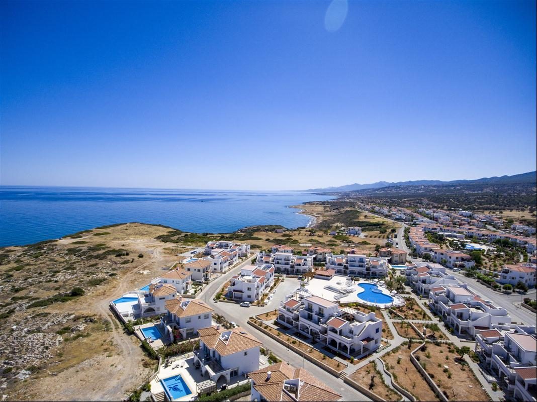 Aerial view of the residential community on the coastal slope above the sea