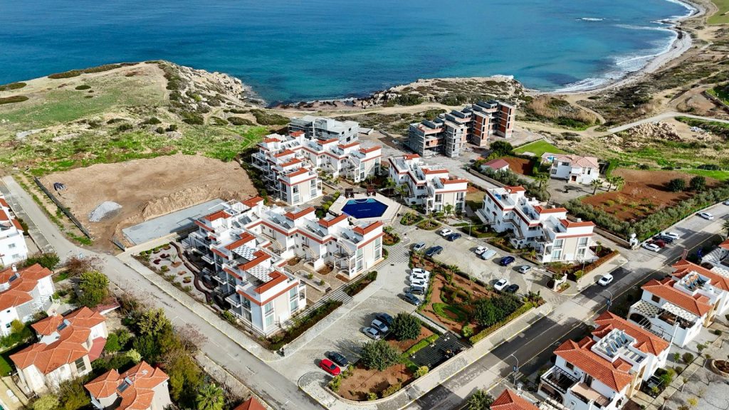 Sea Magic Royal Esentepe: aerial view of apartment blocks beside the coast