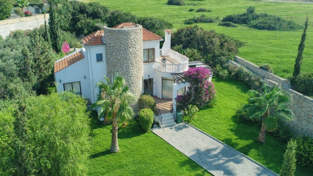 The Morlais Esentepe: aerial view of a white villa with a round stone tower