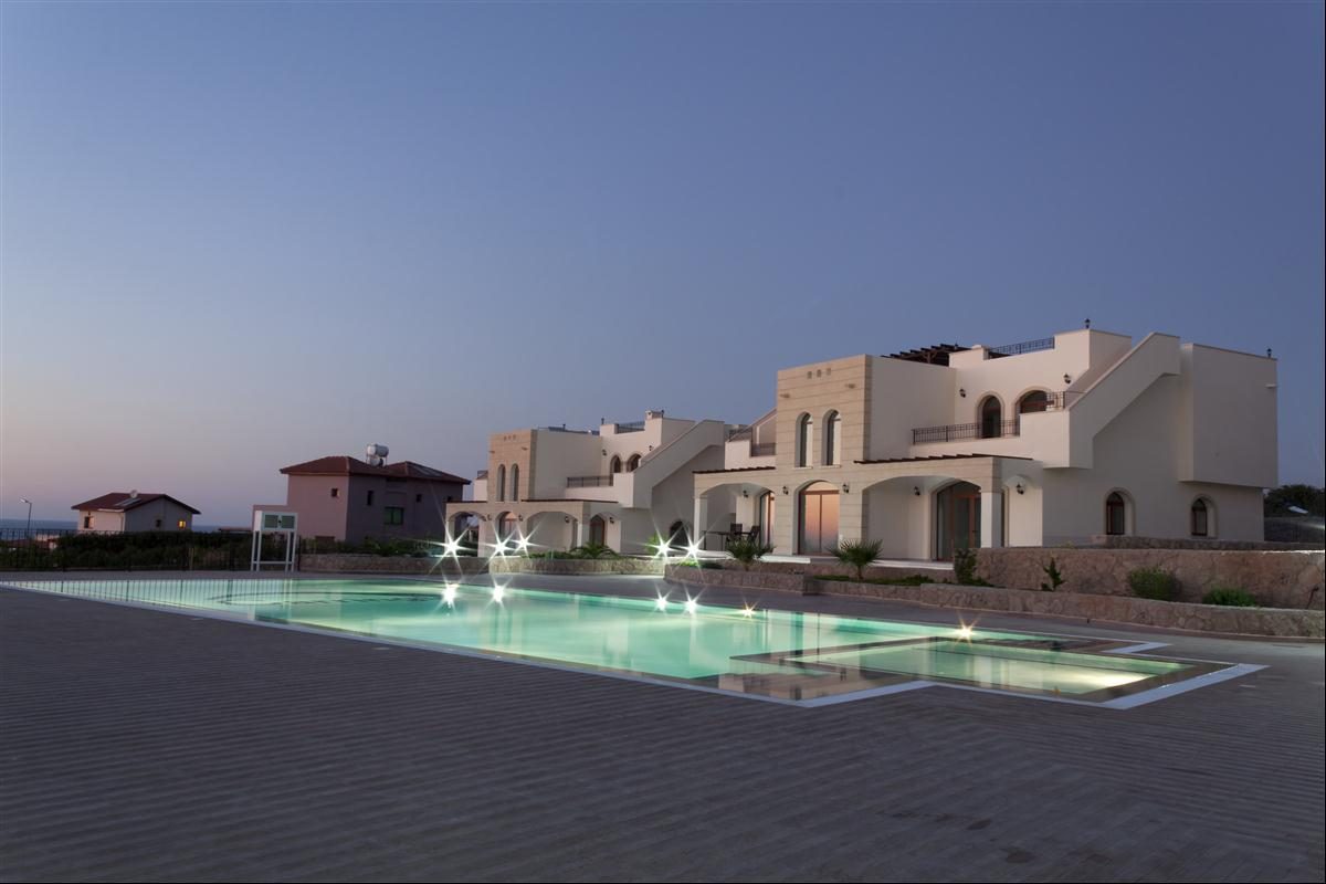 The Residence blocks and communal pool at dusk