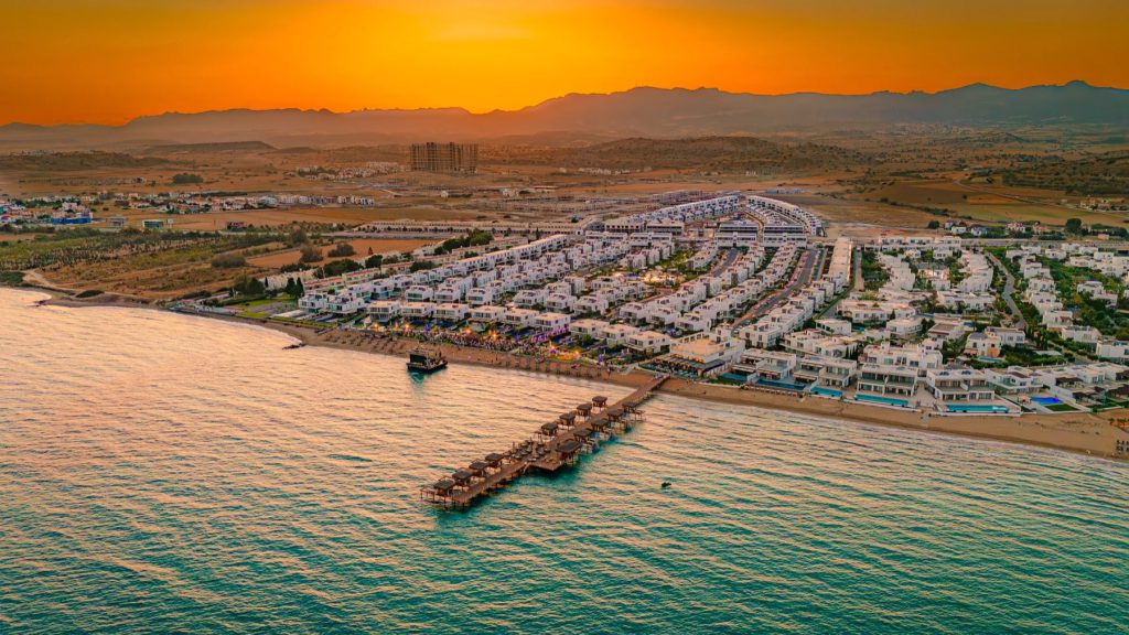 Four Seasons Life aerial view of the coastline and housing at sunset