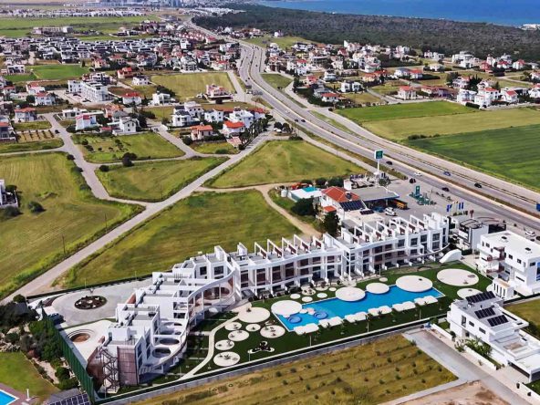 aerial view of Neo Residence white terraced buildings and pool beside the main road