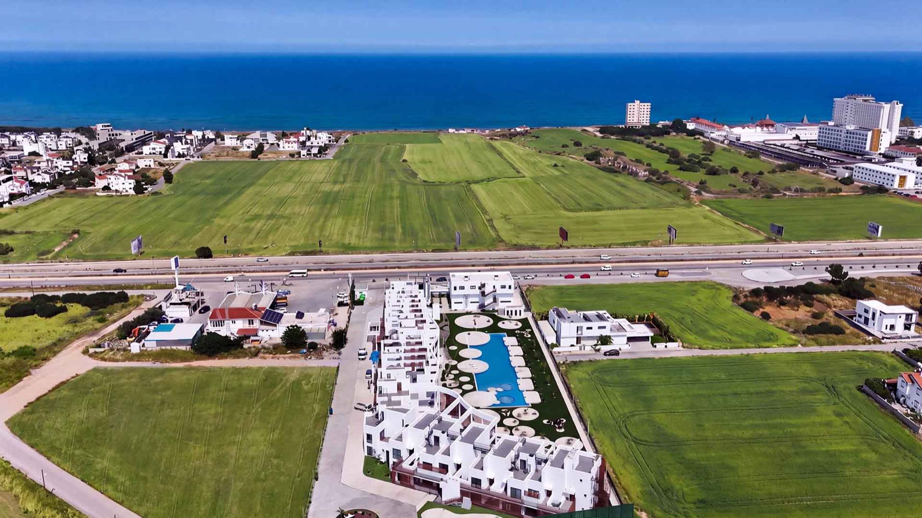 aerial view of Neo Residence complex and swimming pool with sea in the background