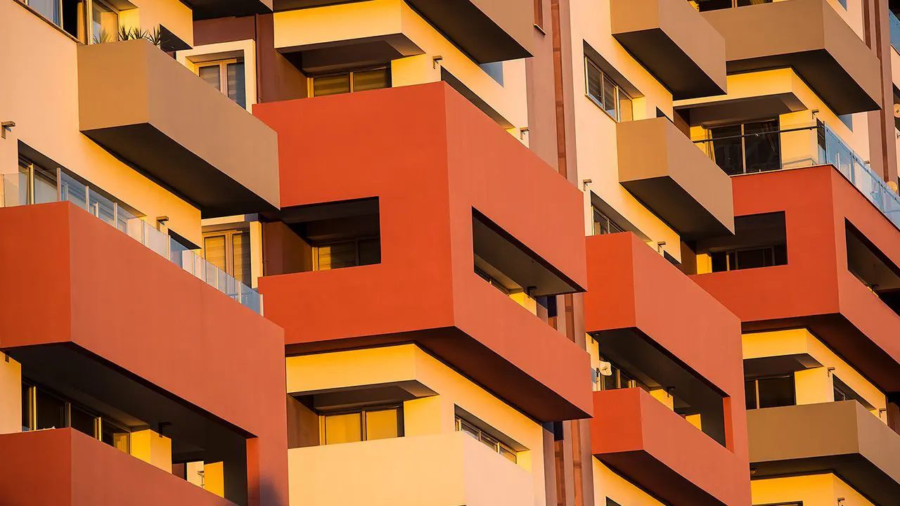 Close view of orange and red balconies on the apartment facade
