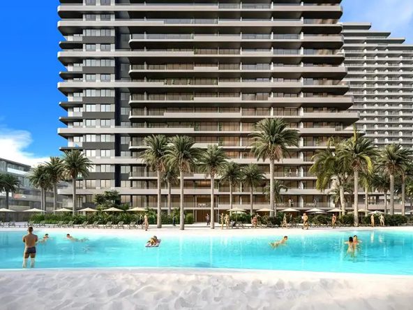 Render of high-rise towers above a large lagoon-style beach pool