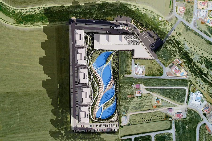 Aerial site render showing the block, pools and surrounding green space