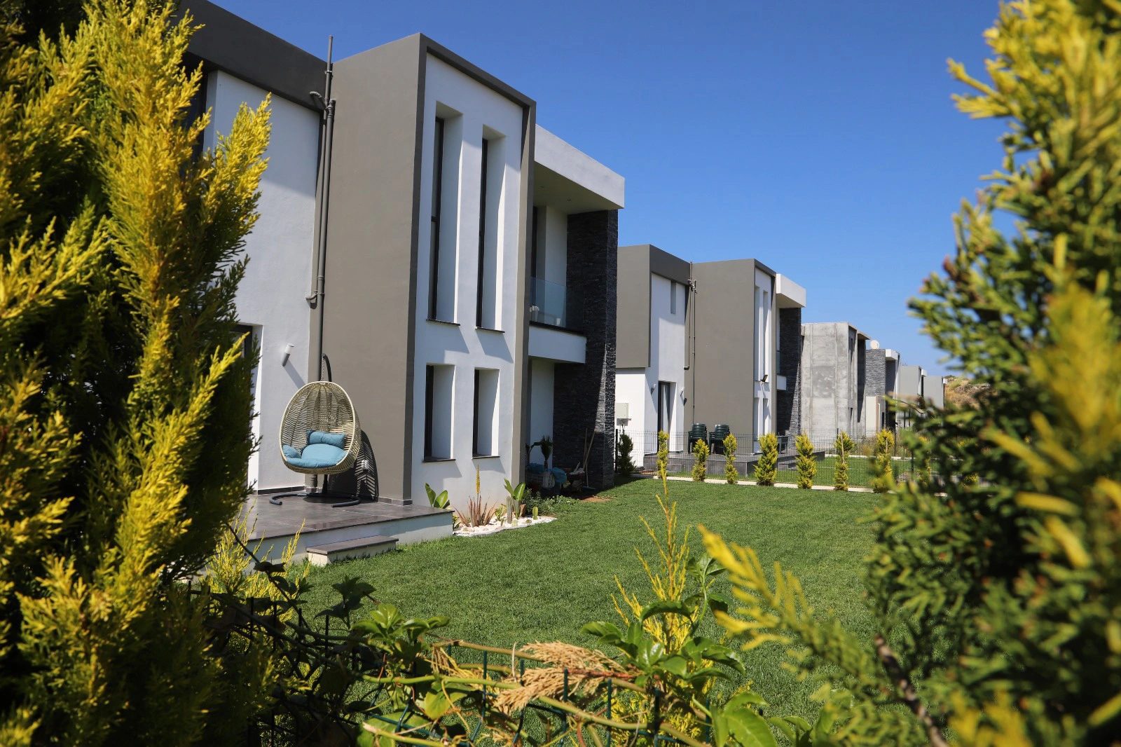 Photograph of villas along a landscaped lawn