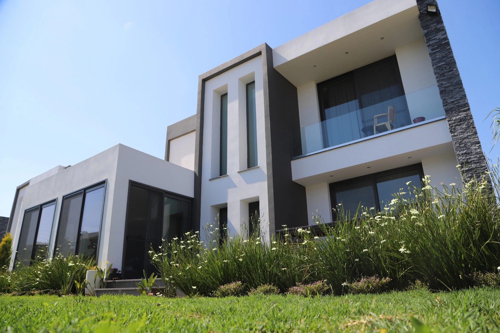 Photograph of a villa corner with planting